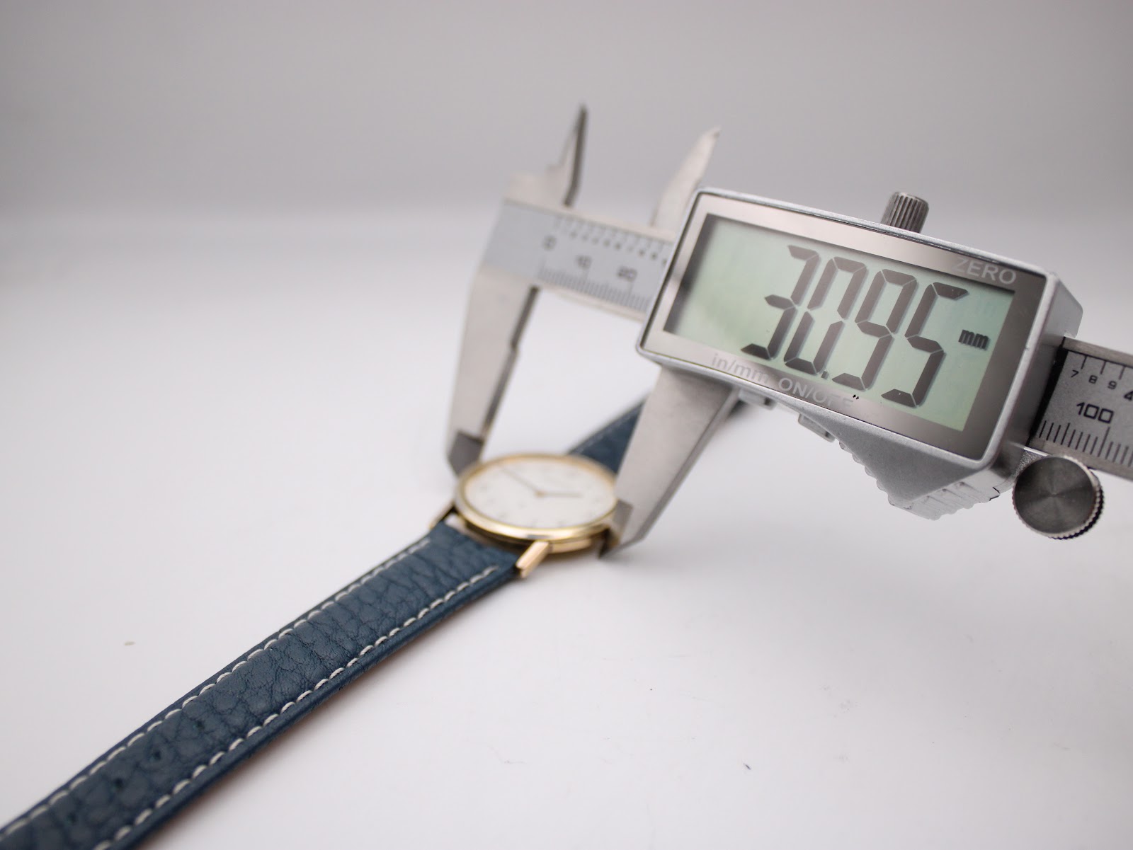 Digital caliper measuring the Certina watch case diameter, displaying 30.95mm.