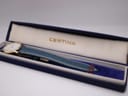 The Certina watch positioned inside its original dark blue presentation box with a gold 'CERTINA' logo.