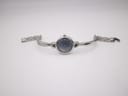 Full view of the Michel Herbelin watch lying flat, showing the integrated bangle bracelet with its clasp unfastened.