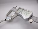 Digital caliper measuring the watch case diameter at 22.15 mm.