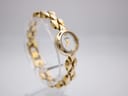 Angled view of Michel Herbelin ladies watch from the left, highlighting the elegant design of the gold-plated integrated bracelet and round case.