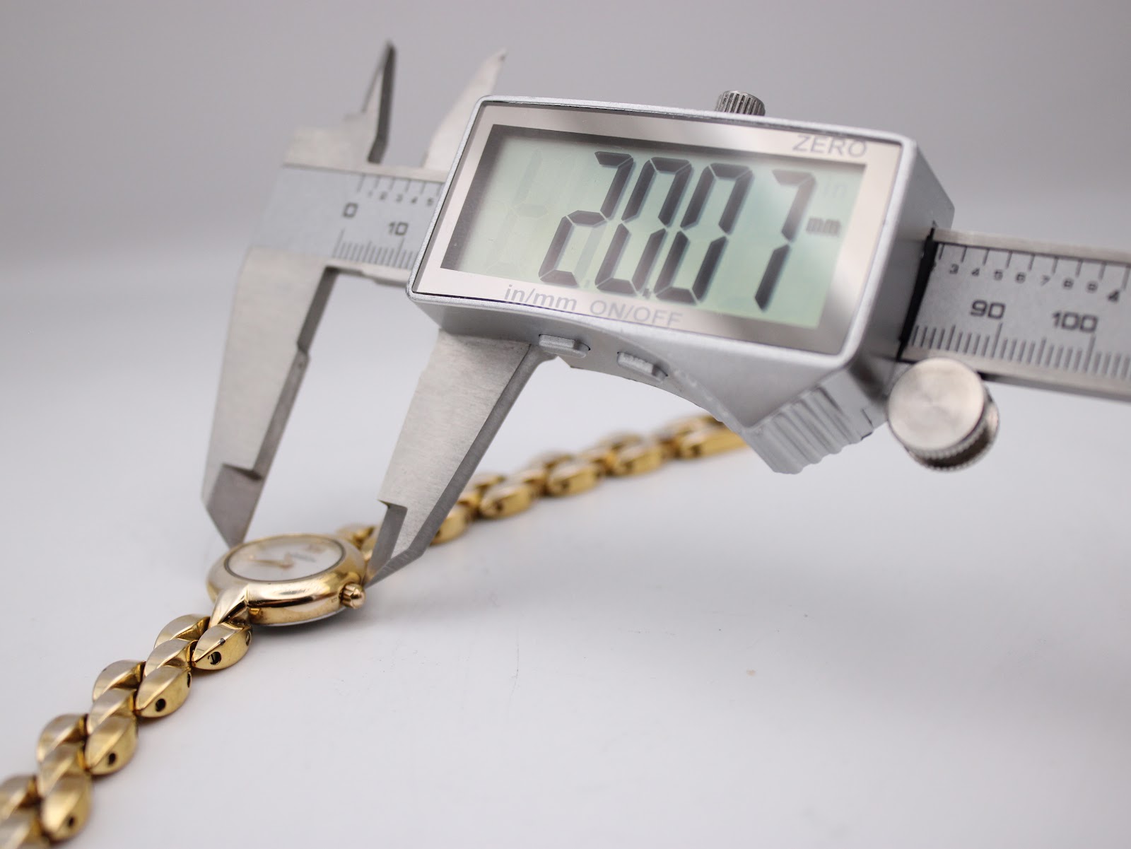 Digital caliper measuring the case diameter of the Michel Herbelin watch, showing a precise measurement of 20.0 mm.