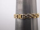 Close-up of the Michel Herbelin bracelet clasp on a wrist sizing cone, showing the signed 'Herbelin' clasp and the bracelet's length fitting around 165mm (approx 16cm).
