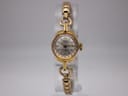 Front view of Oris Super ladies watch with gold case and silver dial on clear stand.