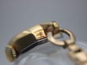 Close-up of the watch lug area, showing "10µ" plating mark on the gold case.