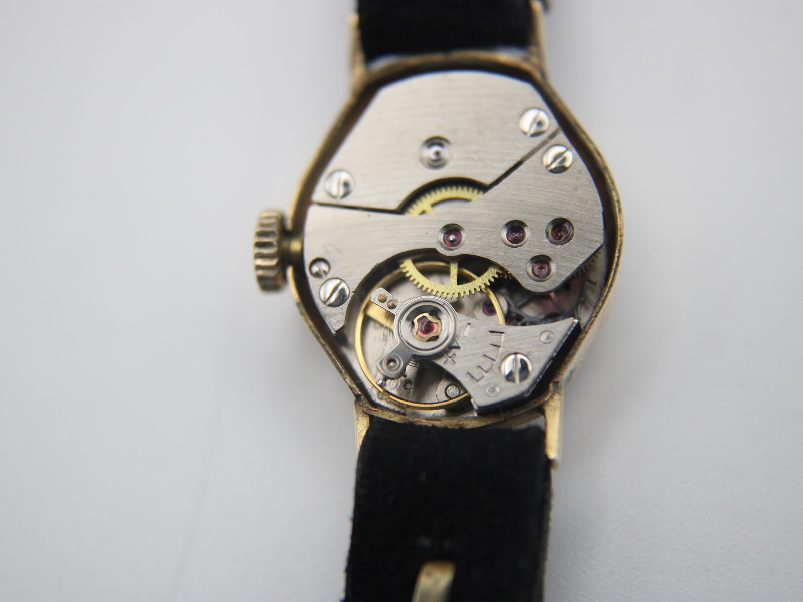 Close-up view of the exposed 17-jewel Swiss mechanical hand-wind movement inside the Bifora watch.