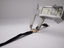 Digital caliper measuring the watch case, displaying a precise diameter of 17.00 mm.
