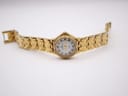 Full view of the Enzo Giovanni watch with its gold integrated bracelet laid out straight.