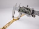 Digital caliper measuring the case diameter of the Enzo Giovanni watch, showing a precise reading of 26.00mm.