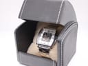 The Kenneth Cole watch nestled inside a black faux leather travel box with a cream interior cushion.