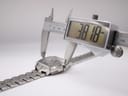 Digital caliper measuring the case diameter of the watch, displaying 38.18mm.