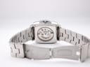 Rear view of the watch, displaying the exhibition case back and the open deployment clasp of the stainless steel bracelet.