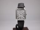Front view of the Emporio Armani AR-0413 watch on a display stand, showing the rectangular case, mother of pearl dial, and black leather strap.