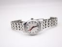 Full length view of the Mondaine watch laid flat, showcasing the entire stainless steel bracelet.