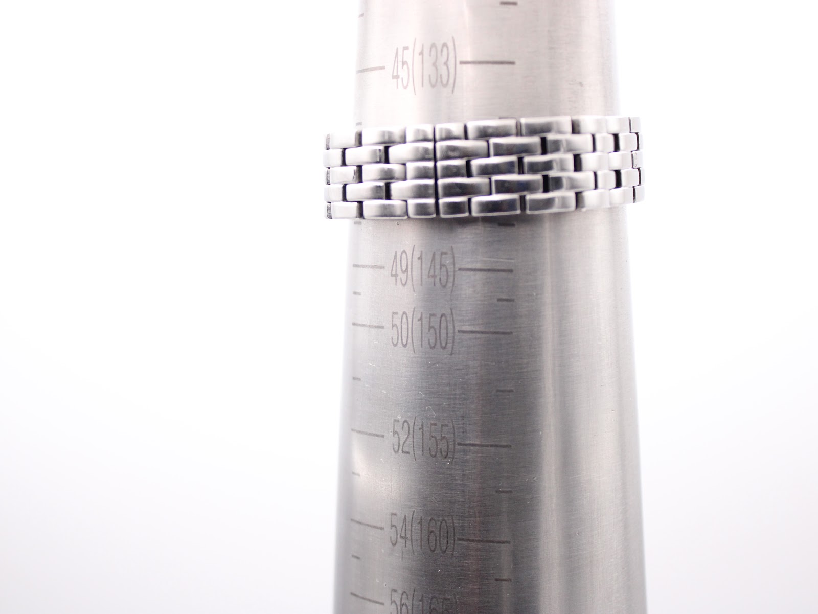 Mondaine watch bracelet wrapped around a wrist sizing gauge, indicating a wrist fit of approximately 140mm.