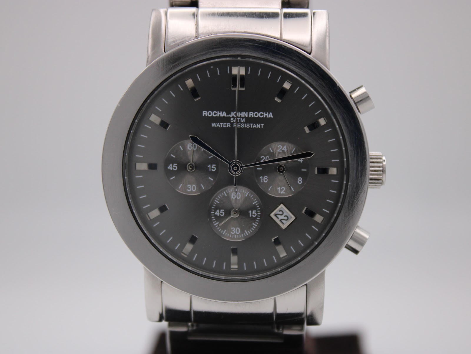 Close-up front view of the Rocha John Rocha watch dial, showing chronograph sub-dials, baton markers, and date window.