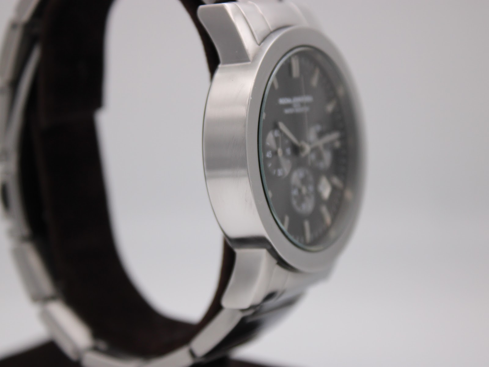 Opposite side view of the watch case, showing the brushed finish of the stainless steel.