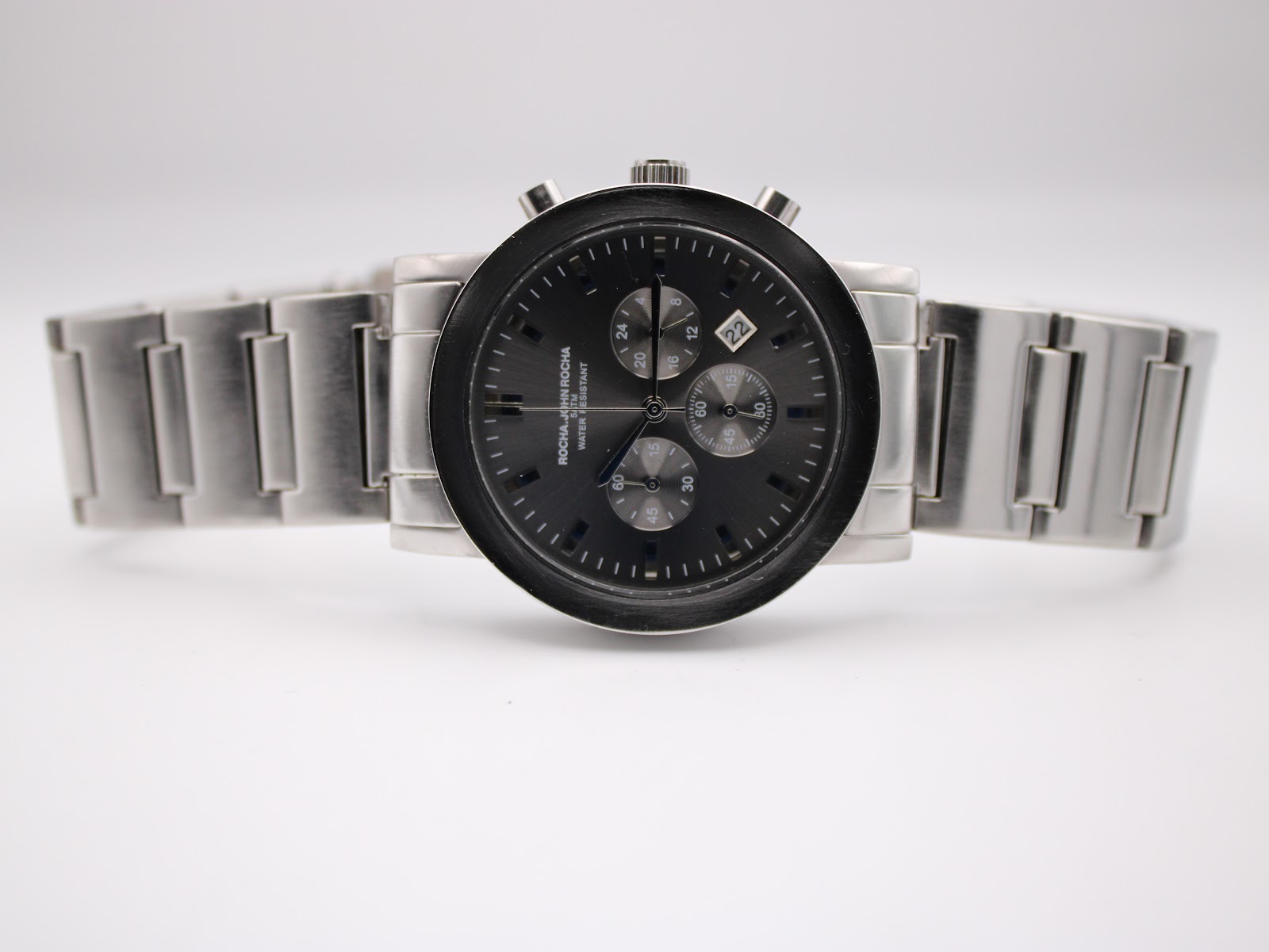 Front view of the watch with its stainless steel bracelet laid flat, showcasing the full length.