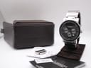 Watch on display stand with its original Rocha John Rocha presentation box, booklet, and spare bracelet link on a white background.