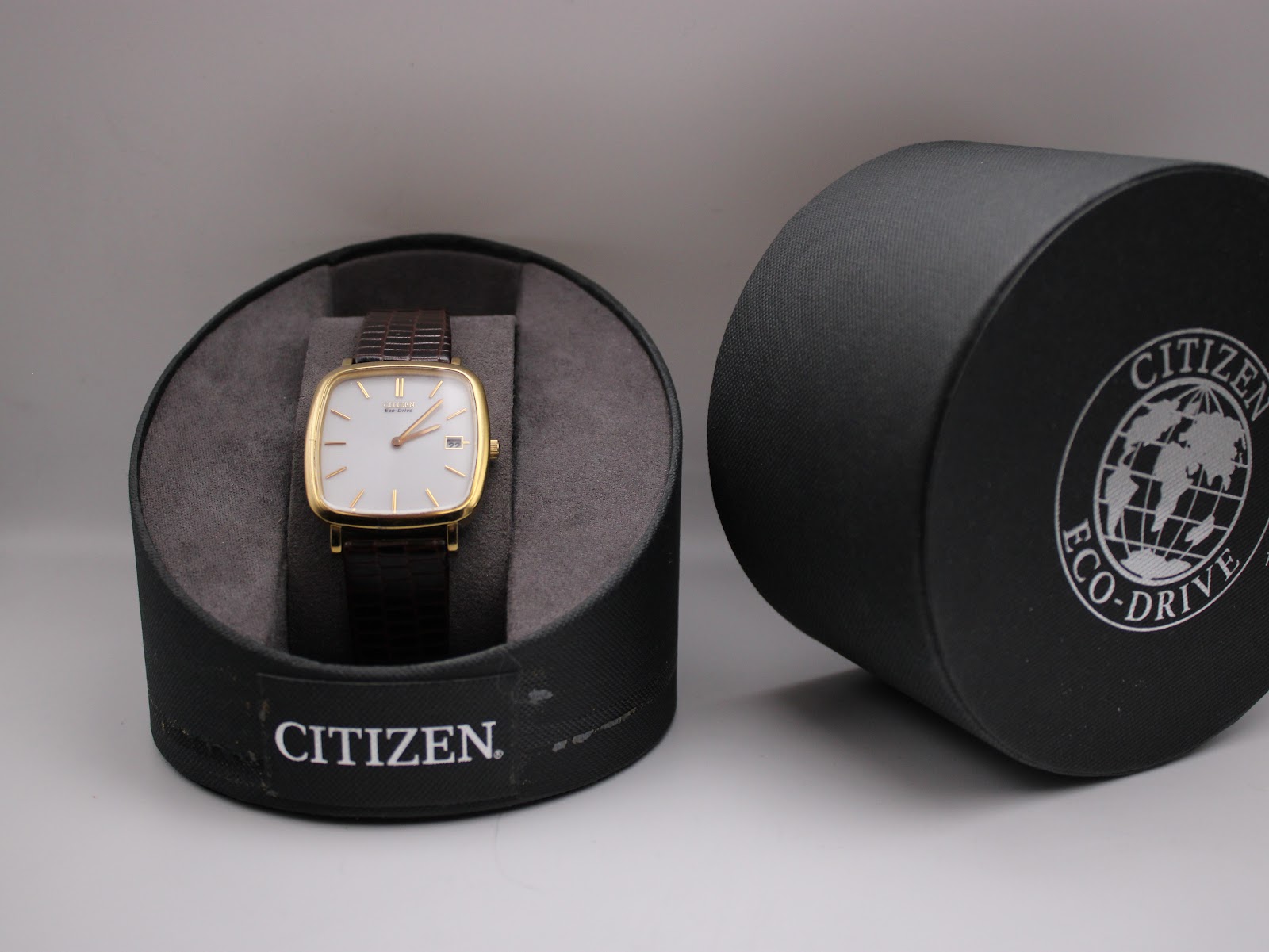 Watch inside its original Citizen Eco-Drive presentation box, with box lid next to it.
