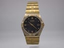Front view of the Citizen Eco-Drive watch with gold-tone case, black dial, gold baton markers, Roman numerals, and crystal-set bezel.