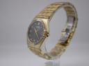 Angled view of the gold-tone Citizen Eco-Drive watch on a display stand, highlighting the bracelet and tonneau case shape.