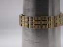Close-up of the gold-tone bracelet on a wrist sizing cone, indicating a circumference of approximately 19.8 cm.