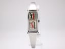Front view of the Gucci 1500L watch on a display stand, showing the rectangular silver stainless steel case and integrated bangle bracelet with its distinctive graphic dial.