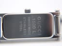 Close-up of the case back of the Gucci 1500L, revealing engravings: "GUCCI", "1500 L", "SWISS MADE", "STAINLESS STEEL", and a serial number "10671567".