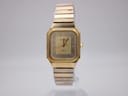 Front view of Bulova P2 gold tone watch with square case, gold dial, and date window.