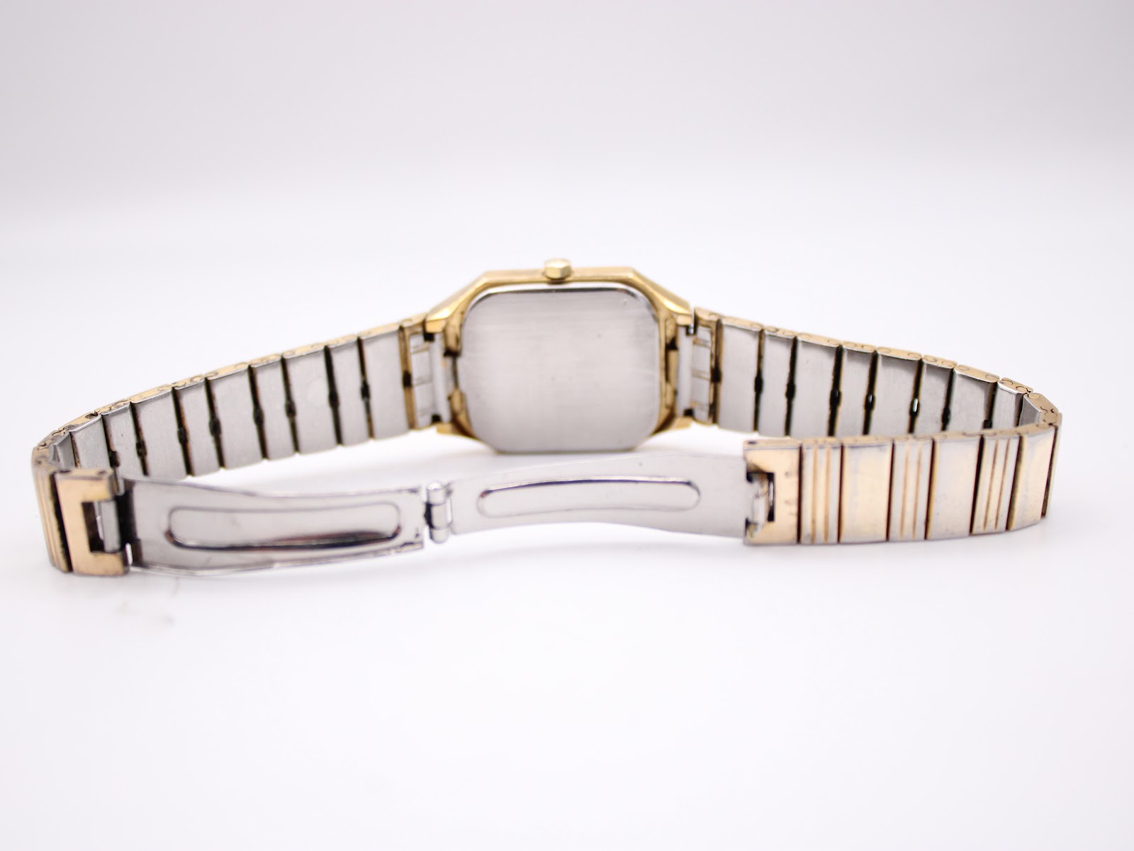 Rear view of the Bulova P2 watch, showcasing the open clasp and the gold tone bracelet links.