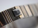 Macro shot of the signed folding clasp on the Bulova watch bracelet, showing the engraved logo.