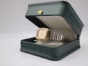 Bulova P2 watch resting inside an open dark green presentation box with a gold crown emblem.