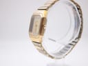 Side profile view of the gold tone Bulova P2 watch and integrated bracelet on a clear display stand.