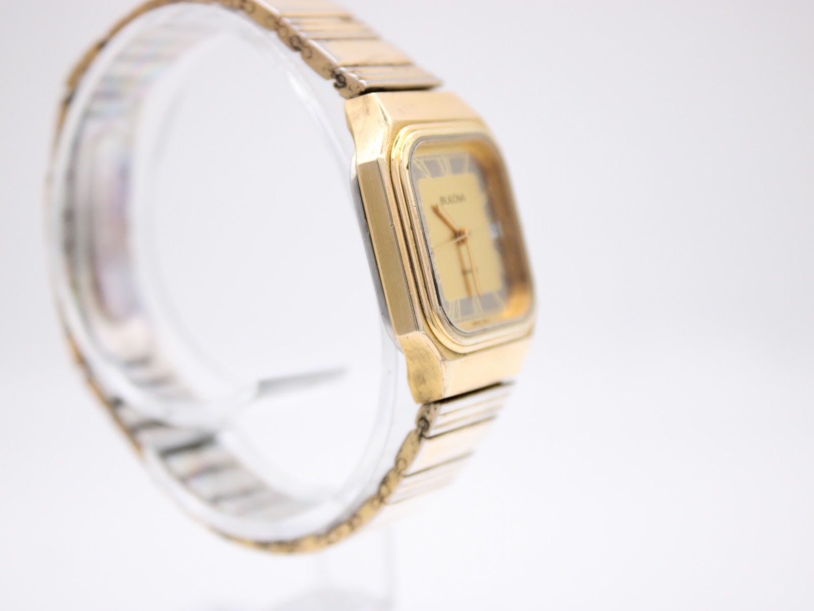 Opposite side profile view of the gold tone Bulova P2 watch, highlighting the case shape and bracelet links.
