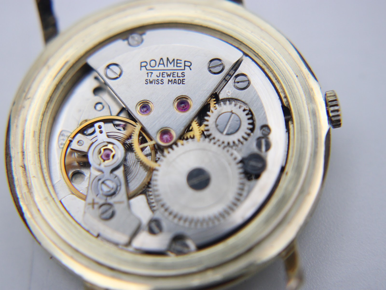 Detailed close-up of the Roamer 17 jewels manual wind mechanical movement, showing intricate gears and rubies.