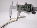 Close-up of the watch case being measured by a digital caliper, displaying a precise diameter of 29.81 mm.