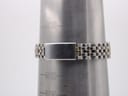 Close-up of the watch bracelet clasp on a ring sizing mandrel, showing the two-tone links and the plain steel clasp.