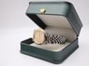 The Bulova Super Seville watch sitting in an open dark green presentation box with a gold crown emblem on the lid.