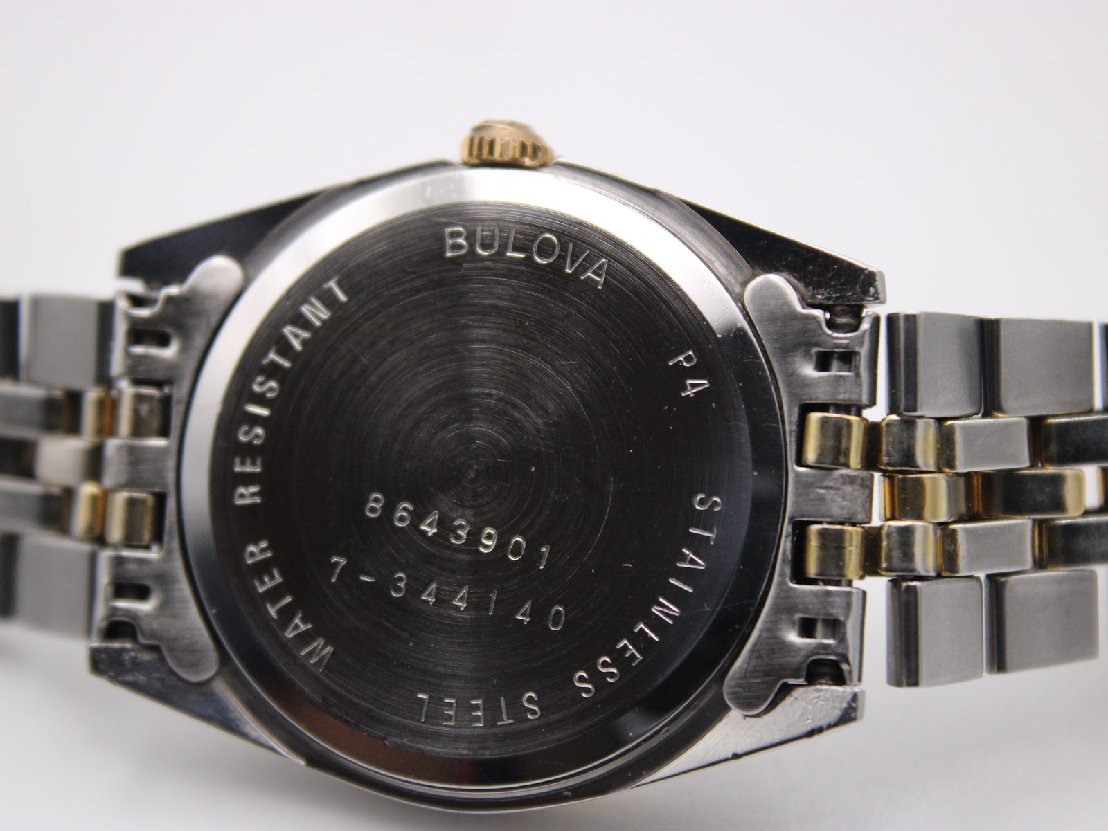 Close-up of the stainless steel case back, engraved with 'Bulova', 'Water Resistant', 'Stainless Steel', and reference numbers 8643901 / 7-344140.