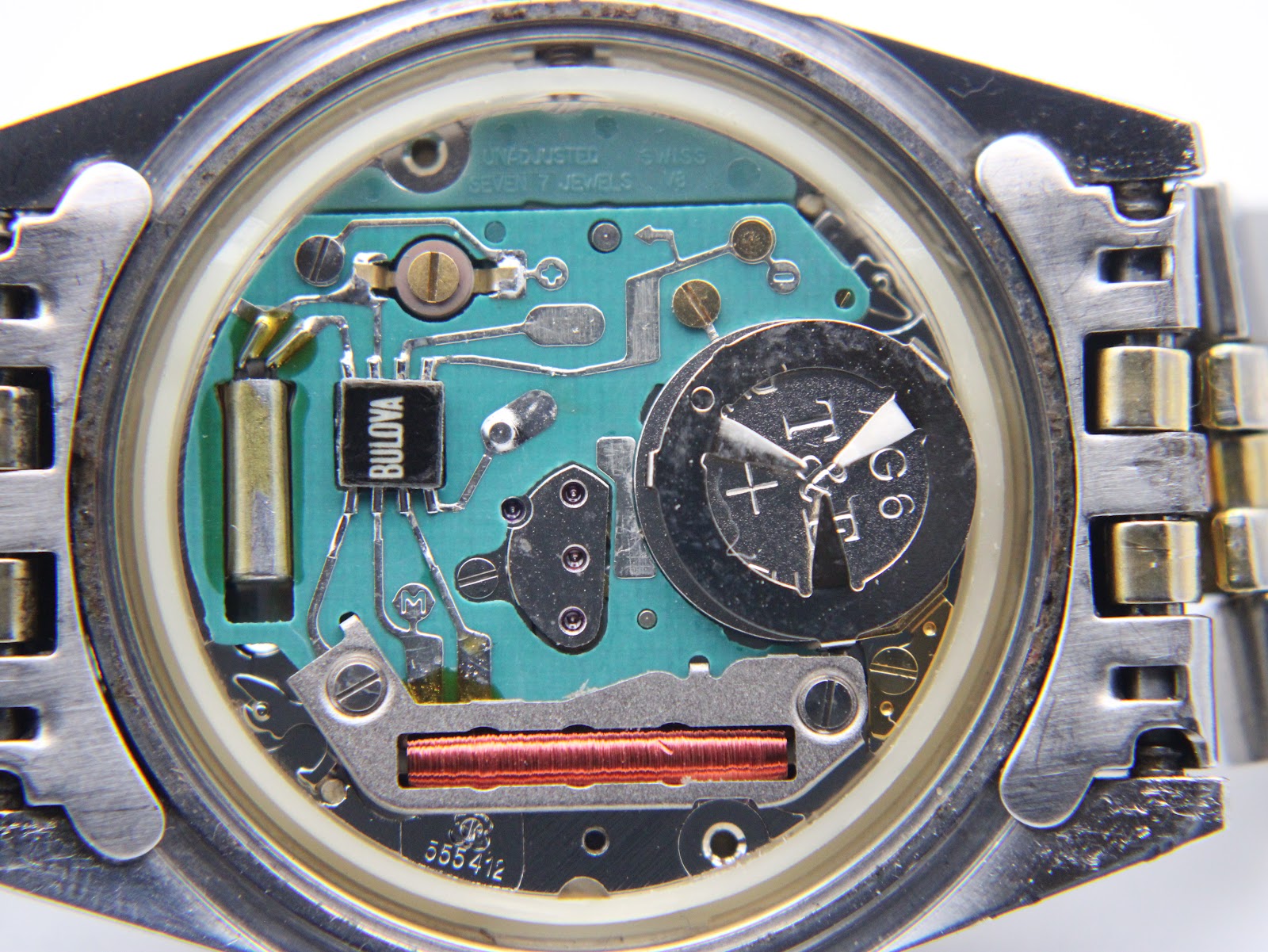 Macro shot of the quartz movement inside the watch, showing the Bulova branded circuit board and battery compartment.