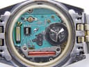 Macro shot of the quartz movement inside the watch, showing the Bulova branded circuit board and battery compartment.