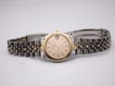 Full front view of the Bulova Super Seville watch with its two-tone bracelet extended on a white surface.