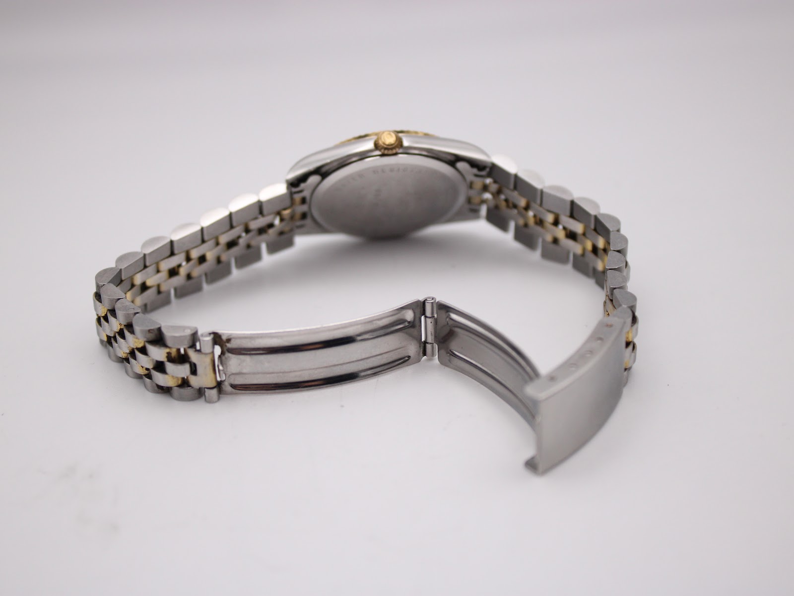 Rear view of the opened two-tone bracelet clasp, showing the stainless steel construction.