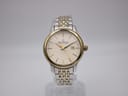 Front view of Dreyfuss & Co. two-tone watch with silver dial and gold baton indices.
