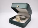 The Dreyfuss & Co. watch displayed in an open dark green box with a crown emblem.