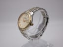 Angled side view of the Dreyfuss & Co. watch showing the gold bezel and two-tone bracelet.