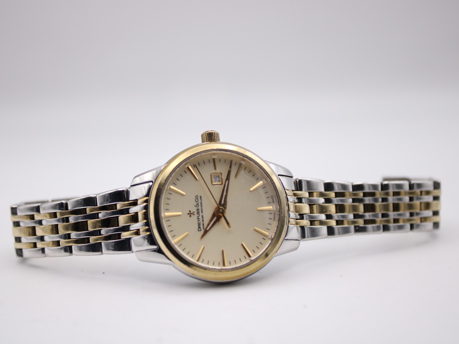 Full view of the watch lying flat, showcasing the dial and bracelet.