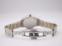 Rear view of the open two-tone bracelet clasp with "stainless steel" marking.