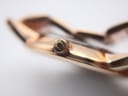 Macro shot of the watch crown, displaying the debossed Bulova tuning fork logo.